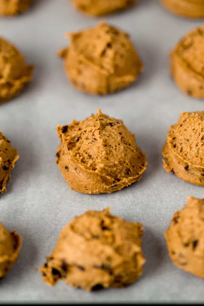 unbaked cookie dough on parchment lined baking sheet