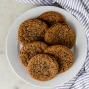 coffee cookies on a white plate next to a napkin