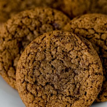 close up side view baked coffee cookies on white plate