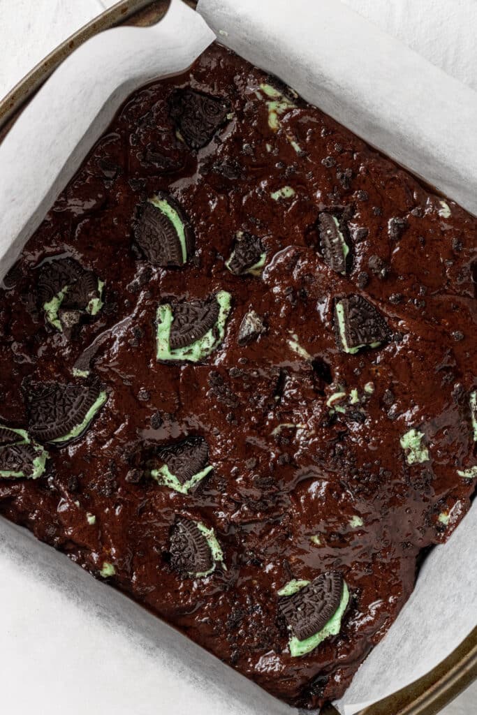 mixture to make mint brownies added to square baking pan lined with parchment paper. 