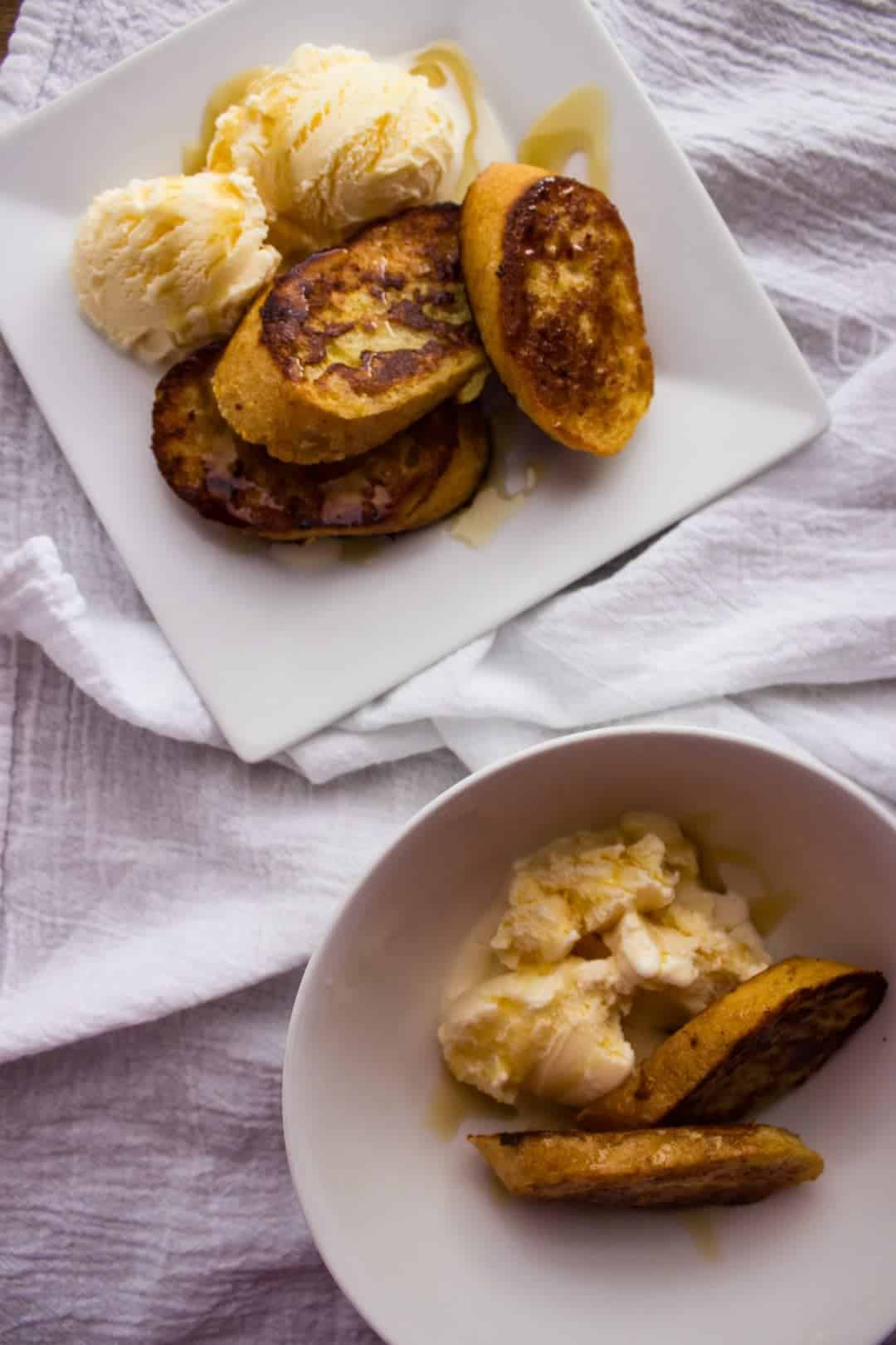 Finished french toast and ice cream in bowl and on plate. 