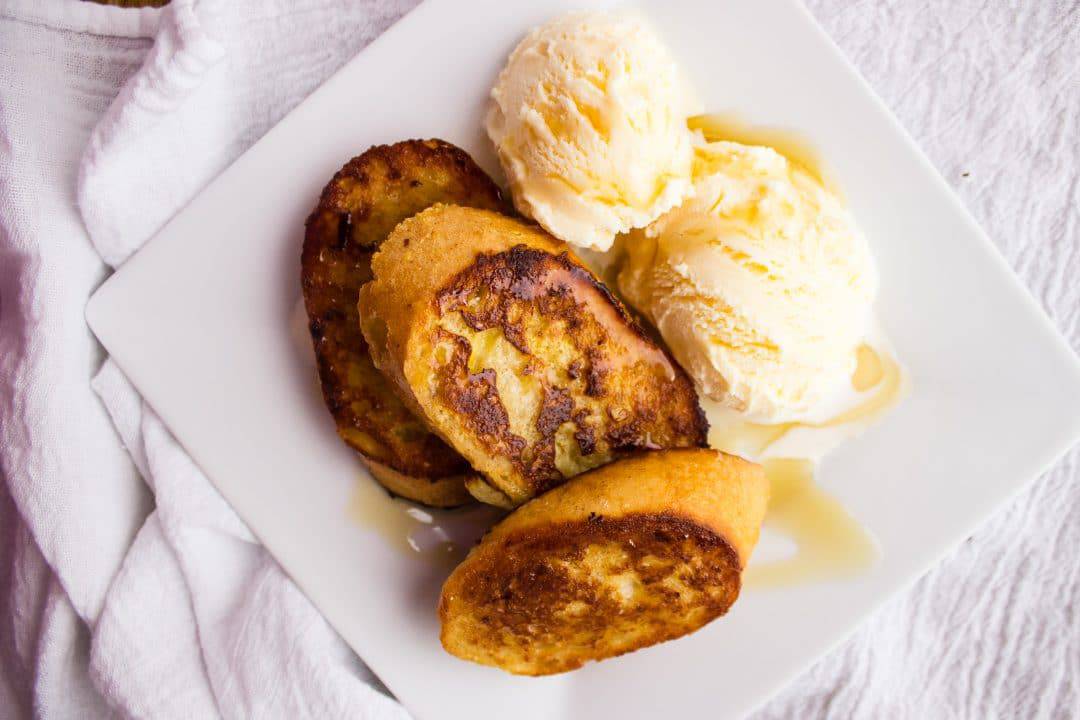 French toast and ice cream on plate. 