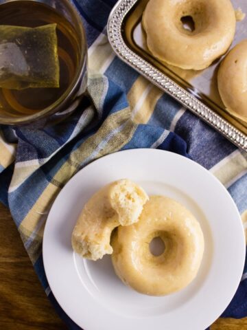 These Vegan Vanilla Donuts are so light, fluffy, and easy to make. Be sure to give them a try with a hot cup of coffee. Perfect for any time of day. simplylakita.com #vegan #donuts