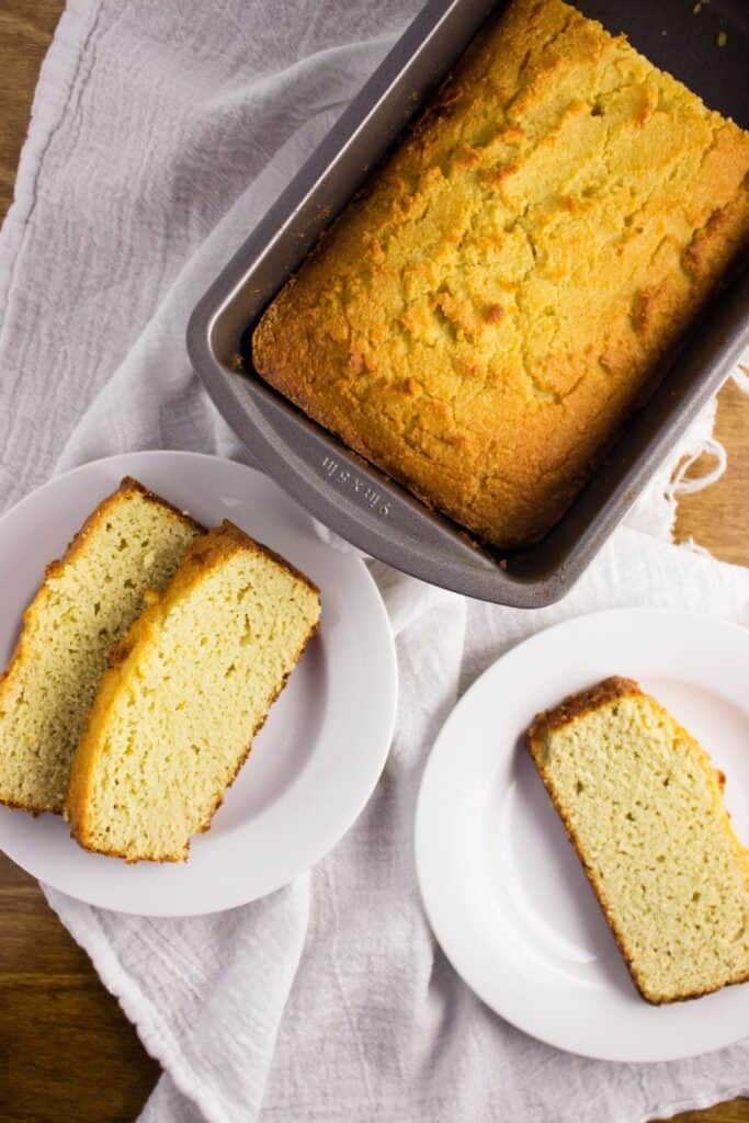 Overhead view of Almond Coconut Flour Bread in loaf pan and plates 