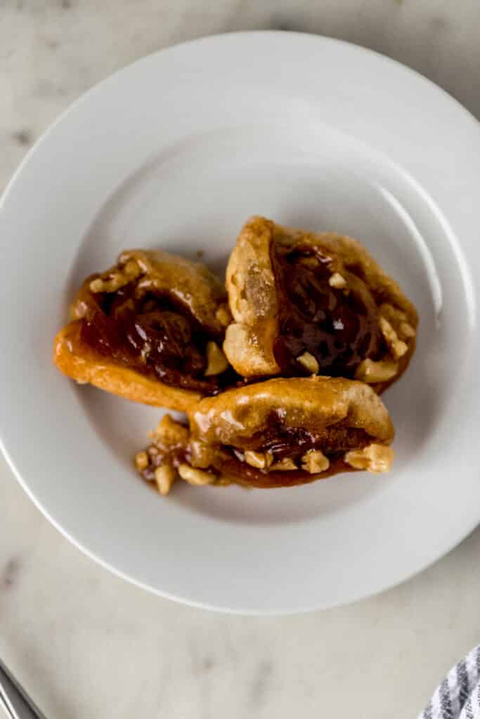 three sticky buns on white plate 