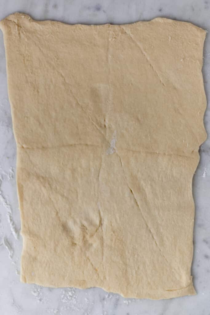 crescent dough rolled out on counter 