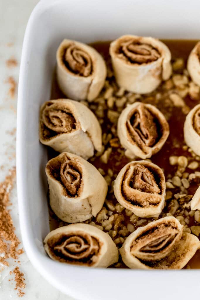 unbaked sticky buns in white baking dish 
