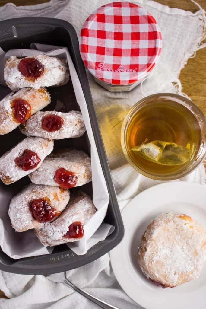 Strawberry Preserves Donuts - Deep fried cake donuts filled with strawberry preserves make the perfect treat to enjoy in bed on Mother's Day with fresh fruit and your favorite cup of coffee. simplylakita.com #donuts #strawberry