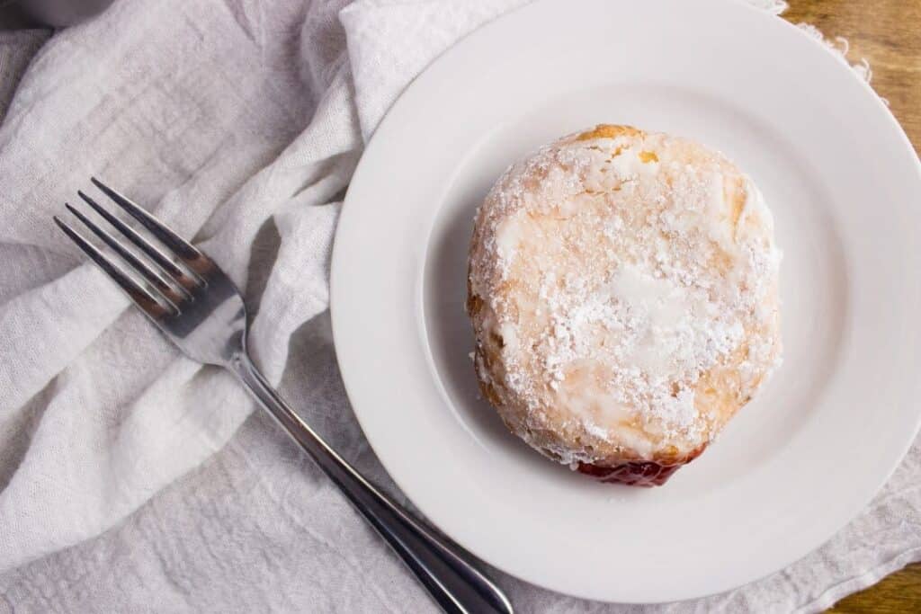 Strawberry Preserves Donuts - Deep fried cake donuts filled with strawberry preserves make the perfect treat to enjoy in bed on Mother's Day with fresh fruit and your favorite cup of coffee. simplylakita.com #donuts #strawberry