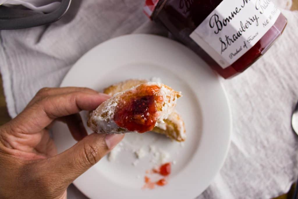 Strawberry Preserves Donuts - Deep fried cake donuts filled with strawberry preserves make the perfect treat to enjoy in bed on Mother's Day with fresh fruit and your favorite cup of coffee. simplylakita.com #donuts #strawberry