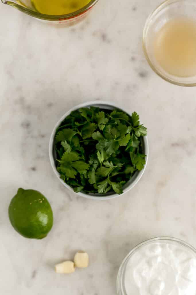 ingredients for cilantro lime dressing in small bowls