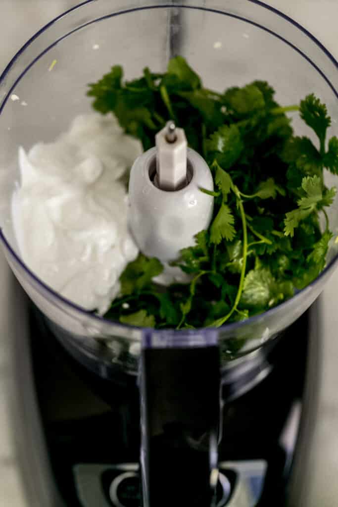 fresh cilantro, lime juice, and greek yogurt in food processor 