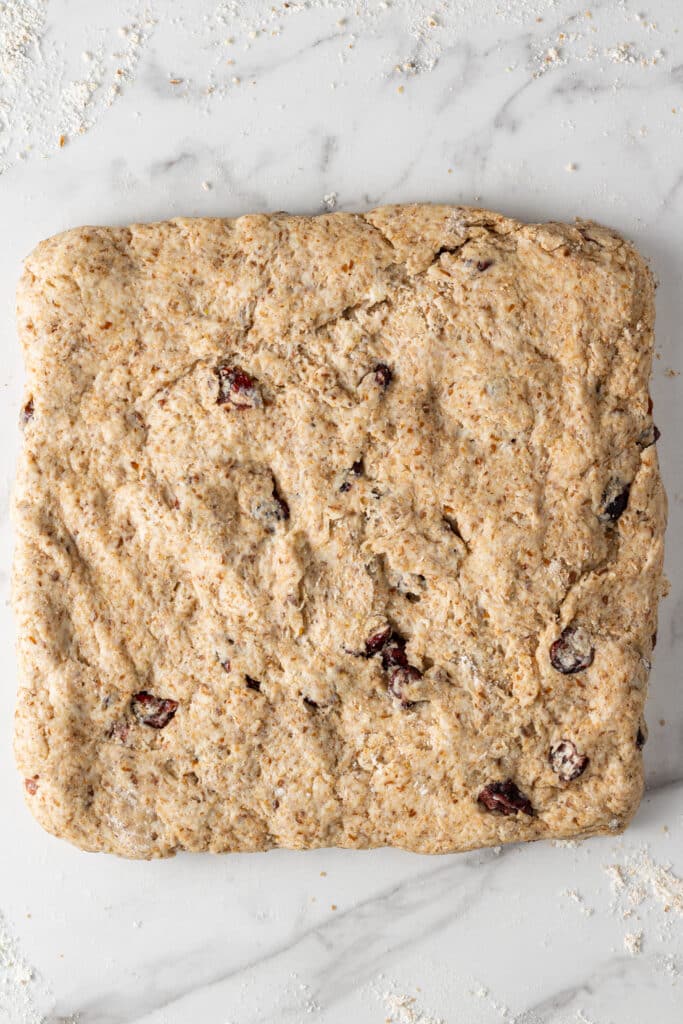 scone dough formed into a square before cutting to bake