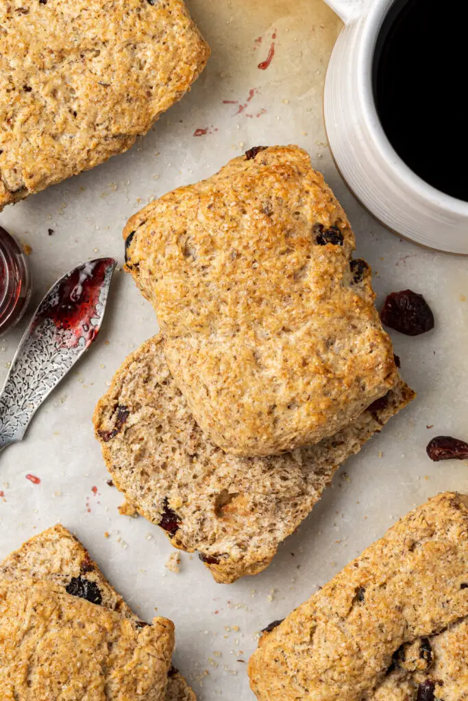flaxseed scone on parchment paper cut in half with jam