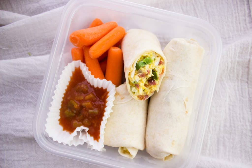 breakfast wraps, carrots, and salsa in clear container