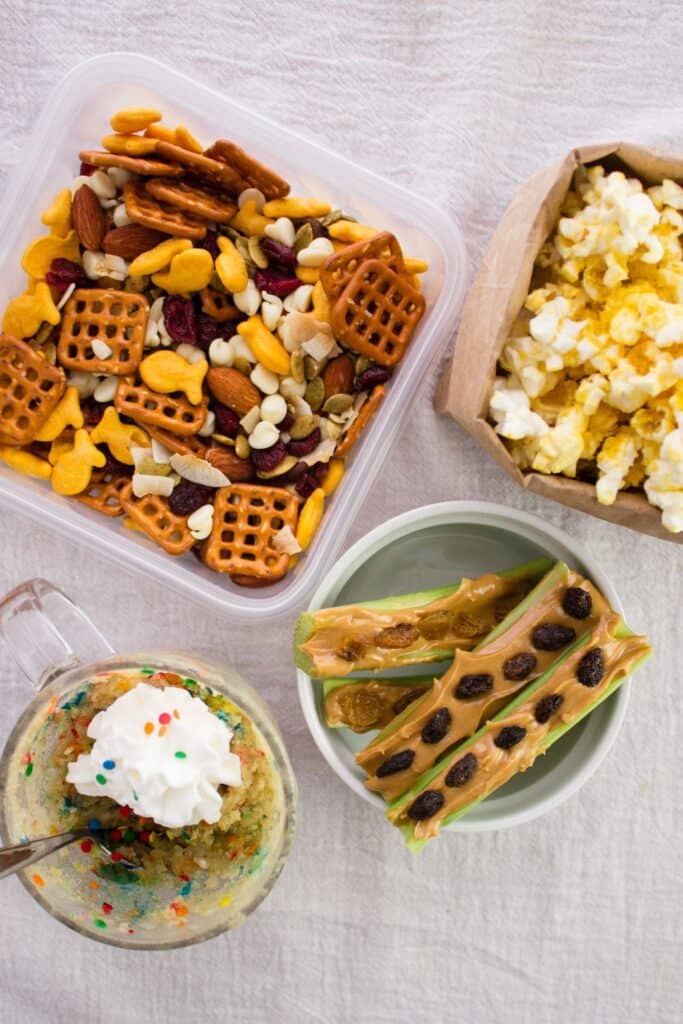 overhead view of finished snacks in separate containers on cloth surface 