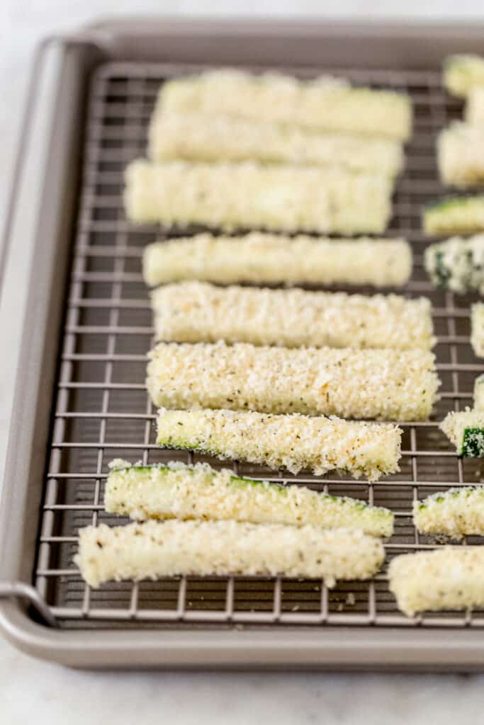 coated zucchini fries on baking sheet before baking 