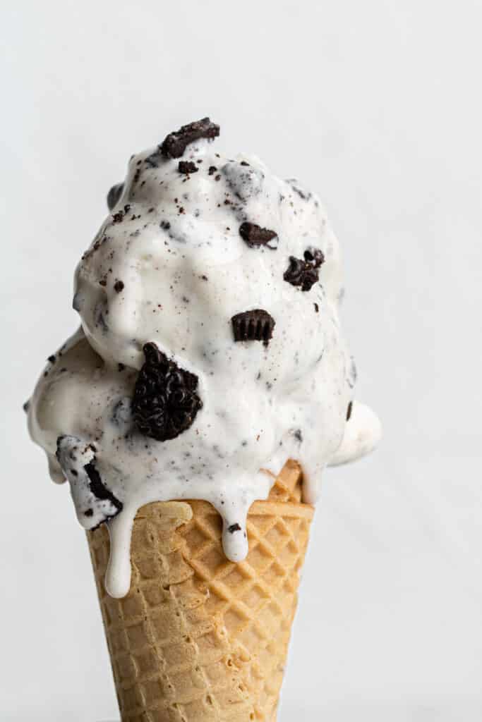 side view cookies and cream ice cream in a sugar cone. 