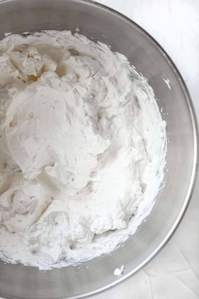overhead view of whipped cream in stand mixer bowl