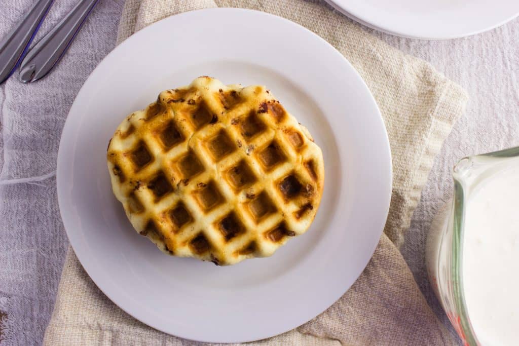 Cinnamon Roll Waffles - Get the delicious taste of cinnamon rolls in the form of a waffle topped with a cream cheese icing. So easy and delicious! simplylakita.com #breakfast #cinnamonroll #waffles