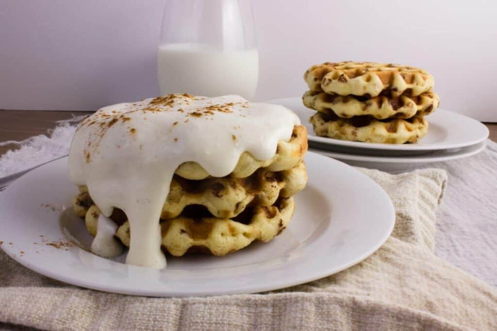 Cinnamon Roll Waffles - Get the delicious taste of cinnamon rolls in the form of a waffle topped with a cream cheese icing. So easy and delicious! simplylakita.com #breakfast #cinnamonroll #waffles