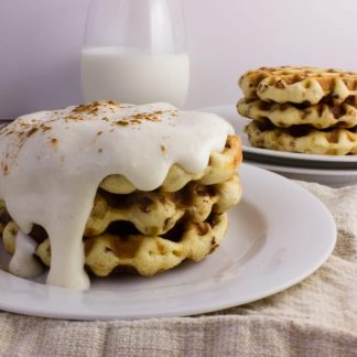 Cinnamon Roll Waffles - Get the delicious taste of cinnamon rolls in the form of a waffle topped with a cream cheese icing. So easy and delicious! simplylakita.com #breakfast #cinnamonroll #waffles