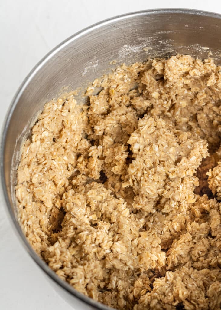 oatmeal cookie ingredients combined together in a stand mixer bowl.