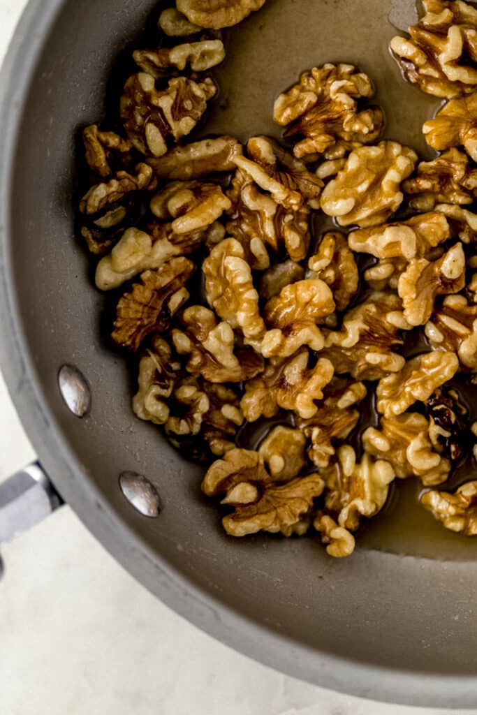 walnuts, butter, sugar, and water in skillet