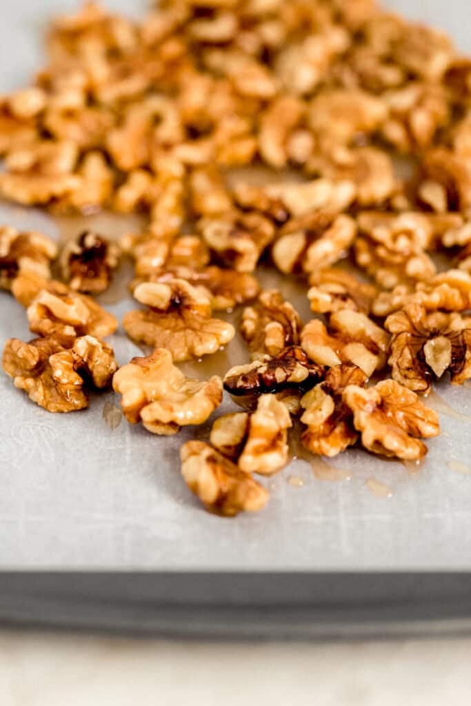 candied walnuts on parchment lined baking sheet.