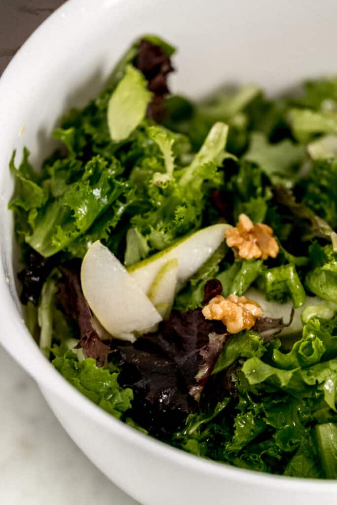 ingredients for salad in large white mixing bowl combined