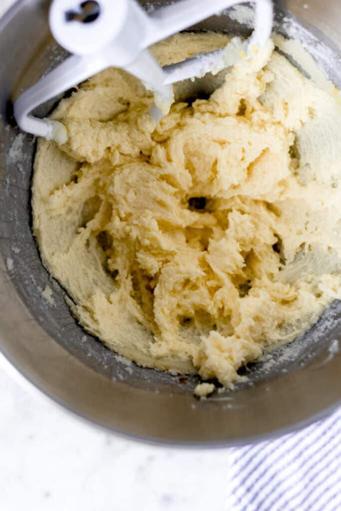 butter, sugar, eggs, and vanilla extract in mixing bowl with paddle attachment