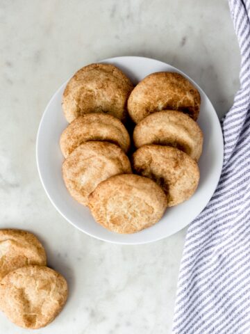 overhead view snickerdoodle cookies on a white plate with a napkin