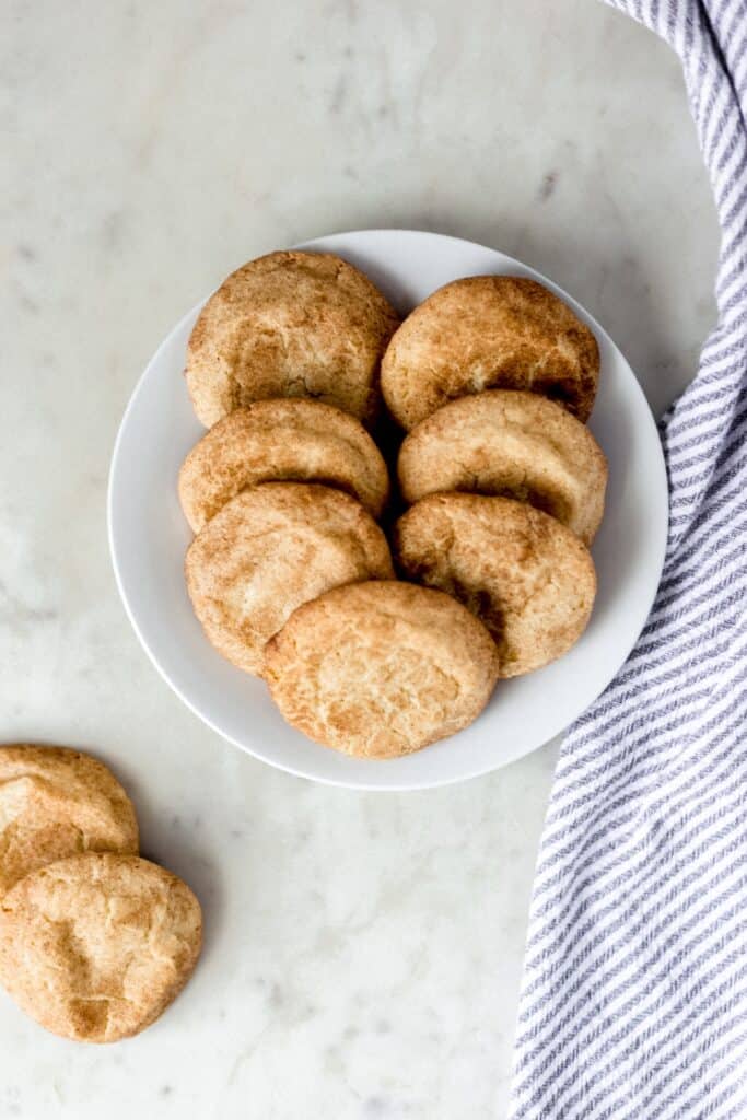 overhead view snickerdoodle cookies on a white plate with a napkin