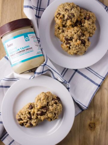 Overhead view of Chocolate Chip Tahini Cookies on two white plates