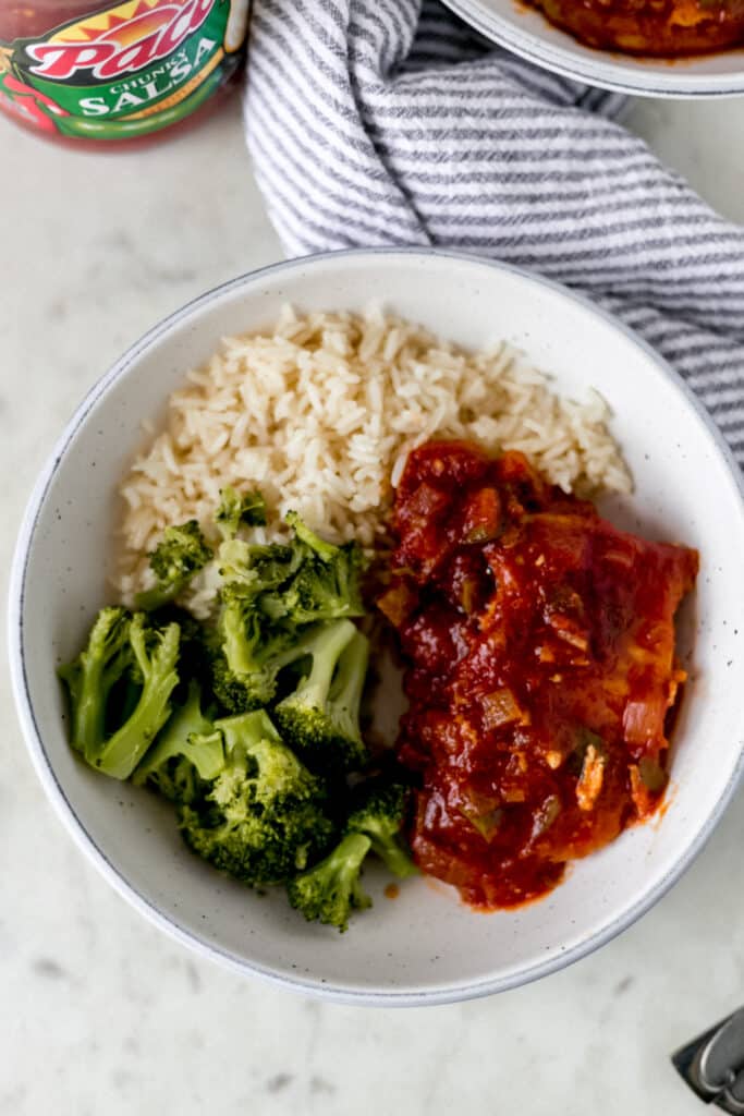 bowl of salsa pork chops, rice, and broccoli 