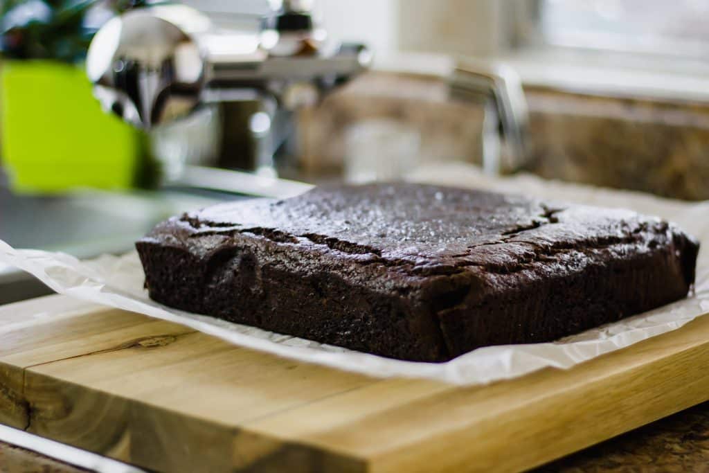 close-up side view of Ginger Cake Squares on wooden board 
