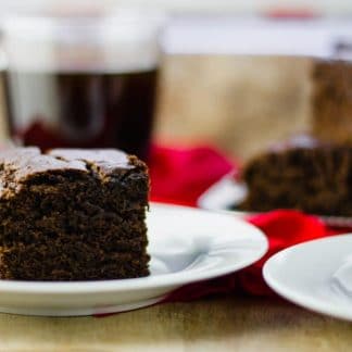 close-up side view ginger cake squares on white plates
