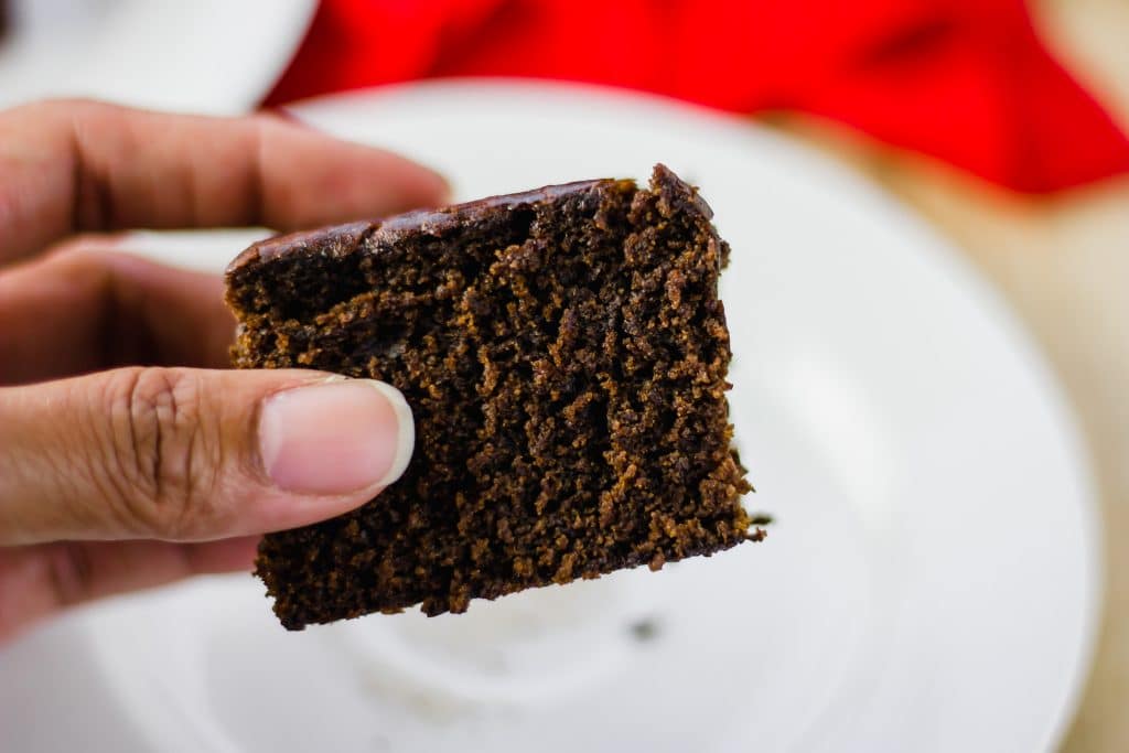 close-up side view hand holding a Ginger Cake Square