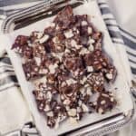 overhead view of trail mix bark on silver tray over napkin