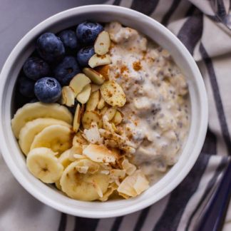 close-up overhead view almond overnight oats with banana, blueberry, and sliced almonds