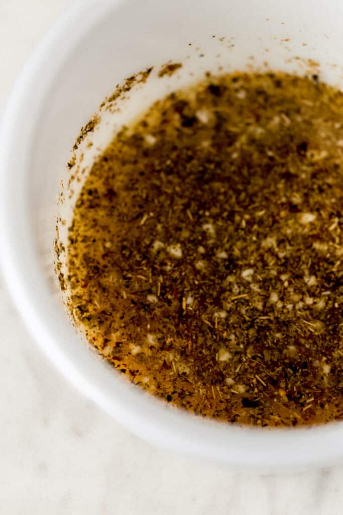 sauce for baked shrimp scampi mixed together in white bowl