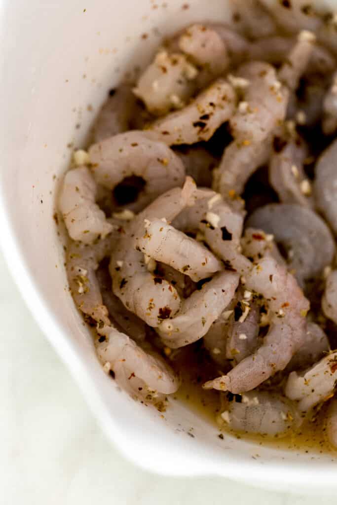 shrimp mixed in white bowl with sauce ingredients
