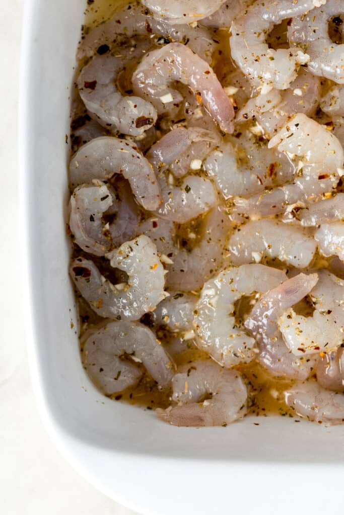 shrimp and sauce for baked shrimp scampi in white baking dish