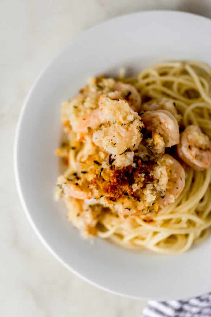 serving of shrimp scampi pasta on small white plate