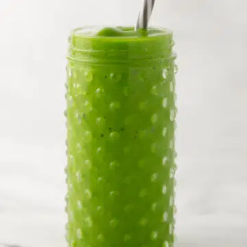 close up side view glass with smoothie inside of it.