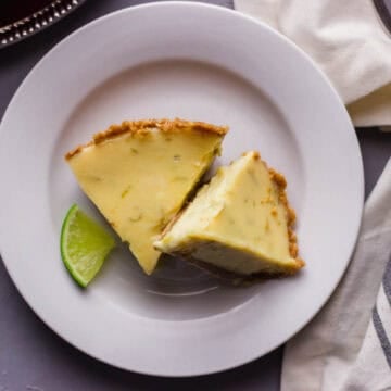 Overhead view of slices of pie on white plate.