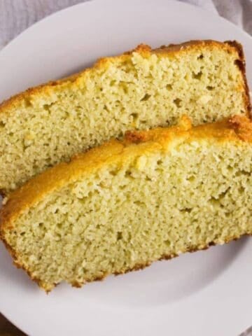Close up of two slices of bread on white plate.