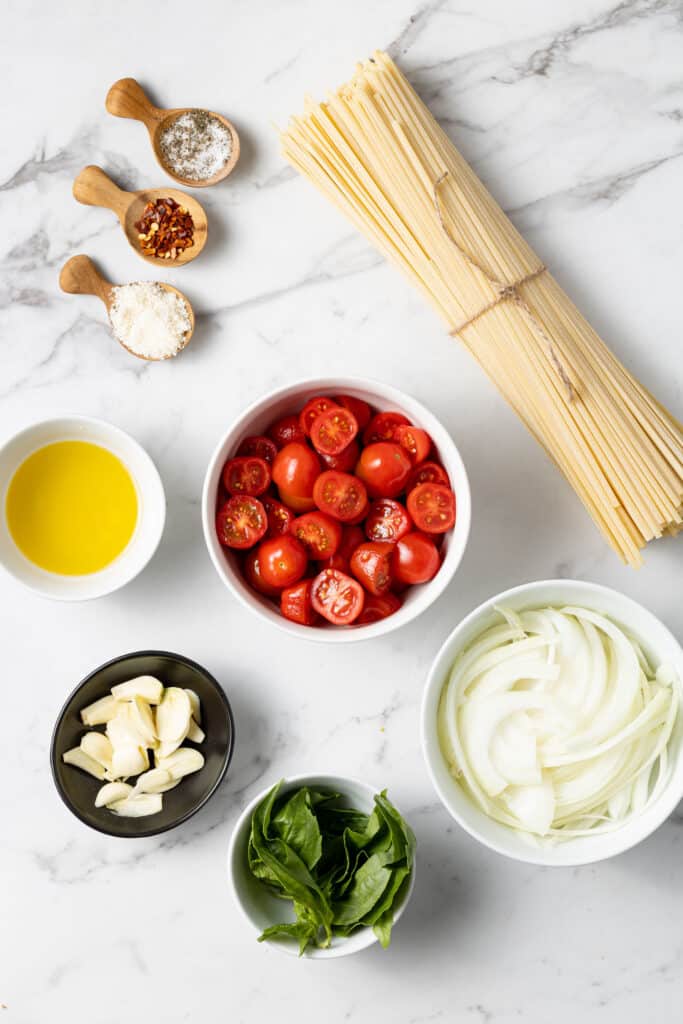 ingredients to make one pan pasta on marble surface. 