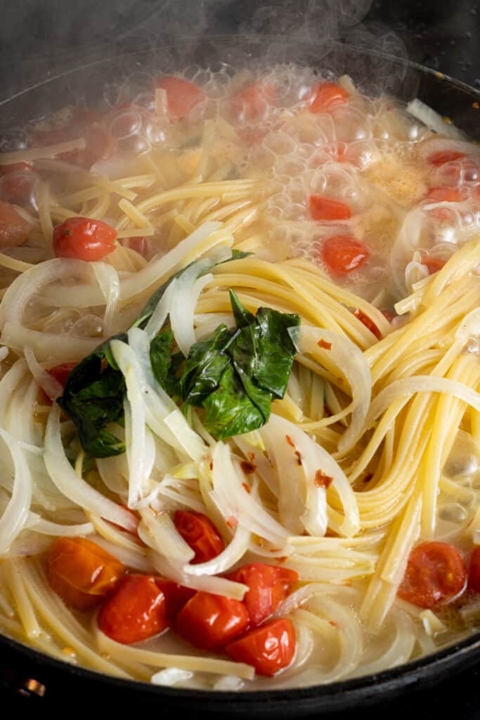 ingredients for one pot pasta in pan coming to a boil 