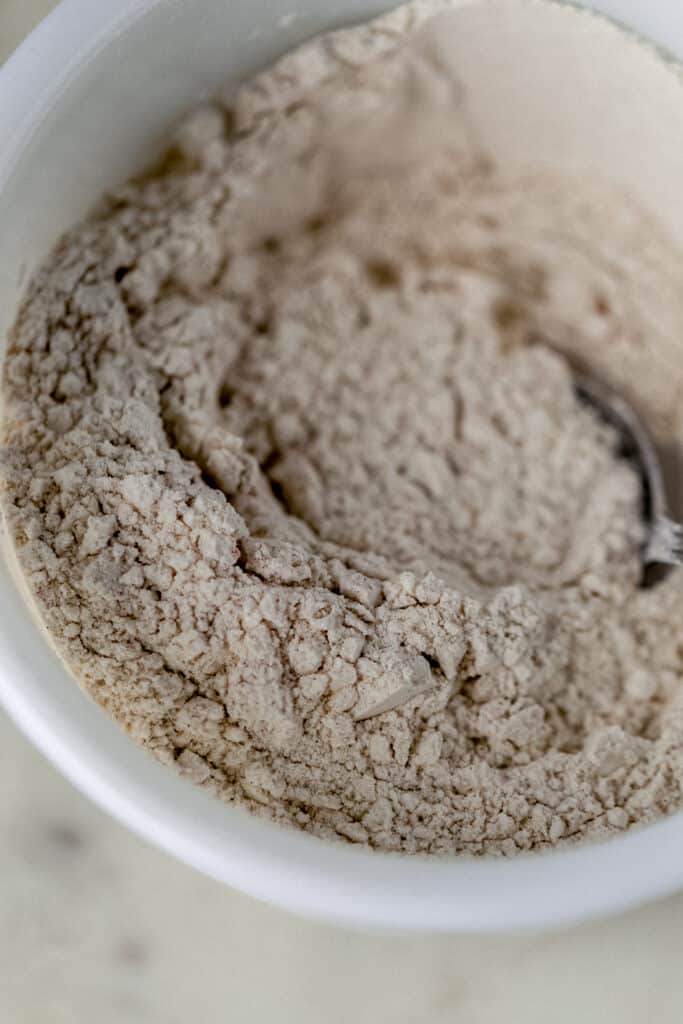 flour mixture in white bowl for peach cobbler muffins
